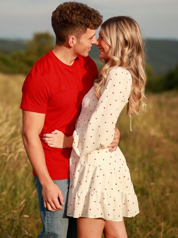 A couple sharing a loving moment outdoors.