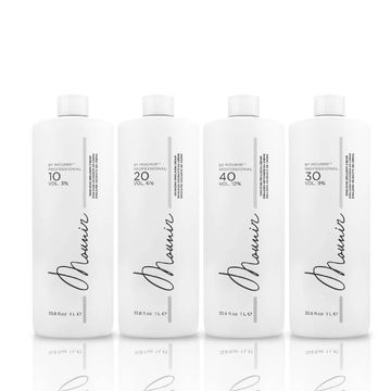 Four white bottles of hair developer with different volume percentages.