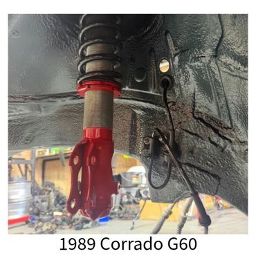 Close-up of a red suspension coilover on a 1989 Corrado G60.