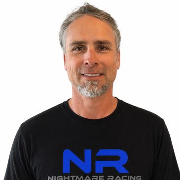 Middle-aged man smiling in black Nightmare Racing t-shirt.