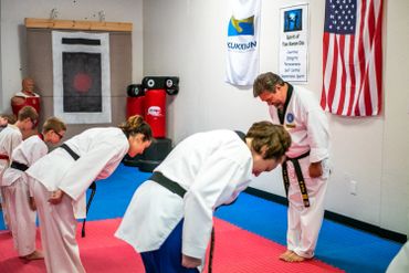 martial arts students bowing to their teacher