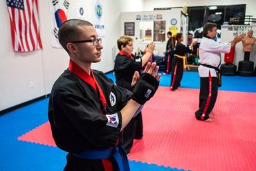 martial arts class with blue and orange belters