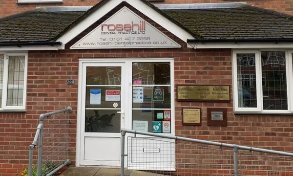 Front entrance of Rosehill Dental Practice in a brick building.