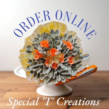 Creative bouquet made of folded dollar bills and orange flowers with butterflies.