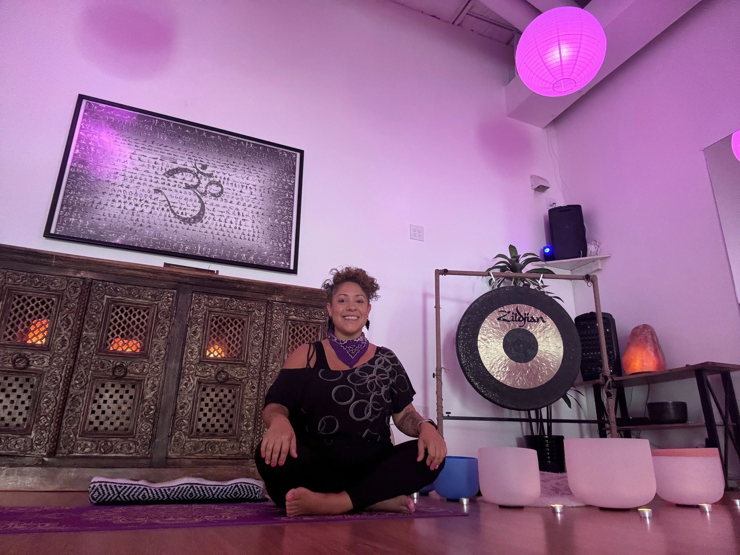 yoga teacher sitting on yoga mat