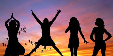 Women Silhouette celebrating in sunset