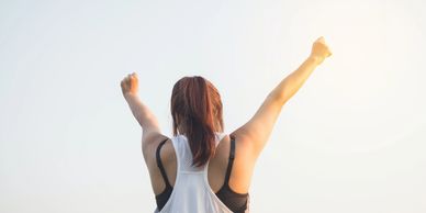 Woman celebrating with raised arms
