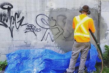 BLASTING GRAFFITI OFF CONCRETE TO LOOK CLEAN AGAIN