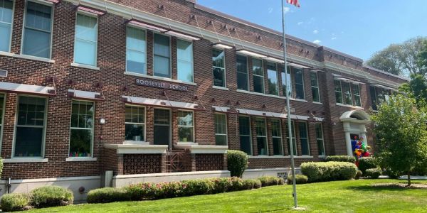 Exterior view of Roosevelt School building on a sunny day.