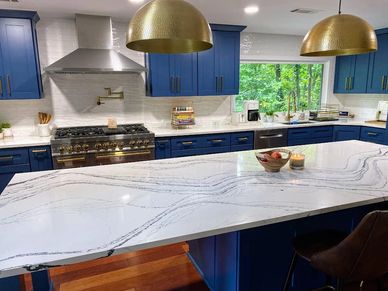 Blue Kitchen with Quartzite Countertops and Gold Fixtures