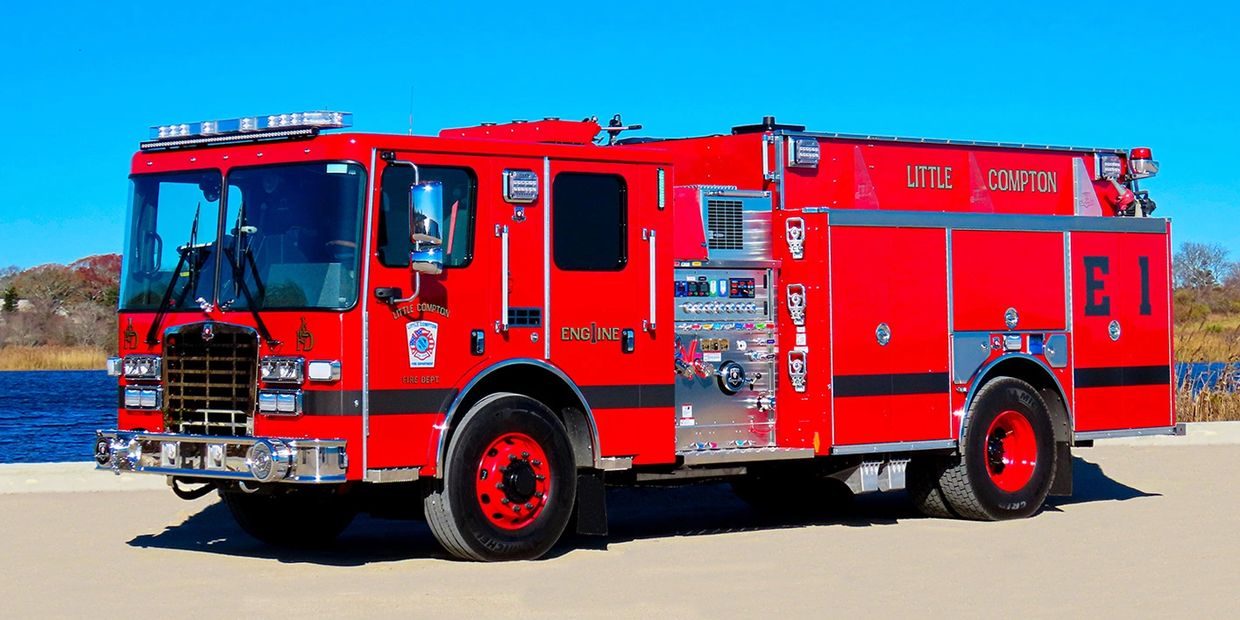 Bright red fire truck from Little Compton Fire Department parked outdoors.