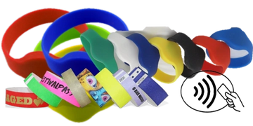 Assorted colorful wristbands and event bands with various designs and texts.