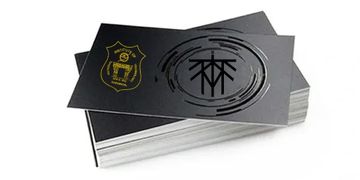 Stack of black business cards with golden and embossed logos.