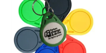 Colorful key fobs arranged in a flower shape with a company-branded tag.