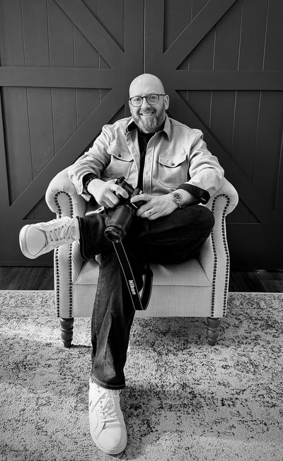 Matt Jury sitting in a chair with camera and Rolex GMT Master II - M126710BLRO-0001 "Pepsi"