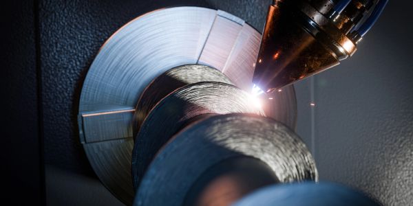 Close-up of laser cutting a metal coil.