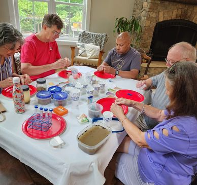 group of people at a table testing a soil sample