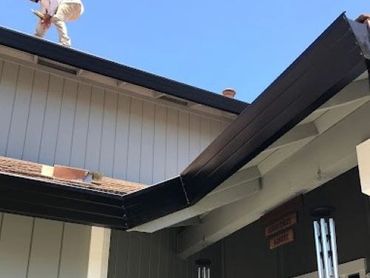 Santa Rosa black gutters with leaf guards for heavy oak debris.