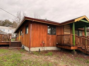 Custom dark red seamless gutter installation on a brown cedar-sided home in Sonoma County