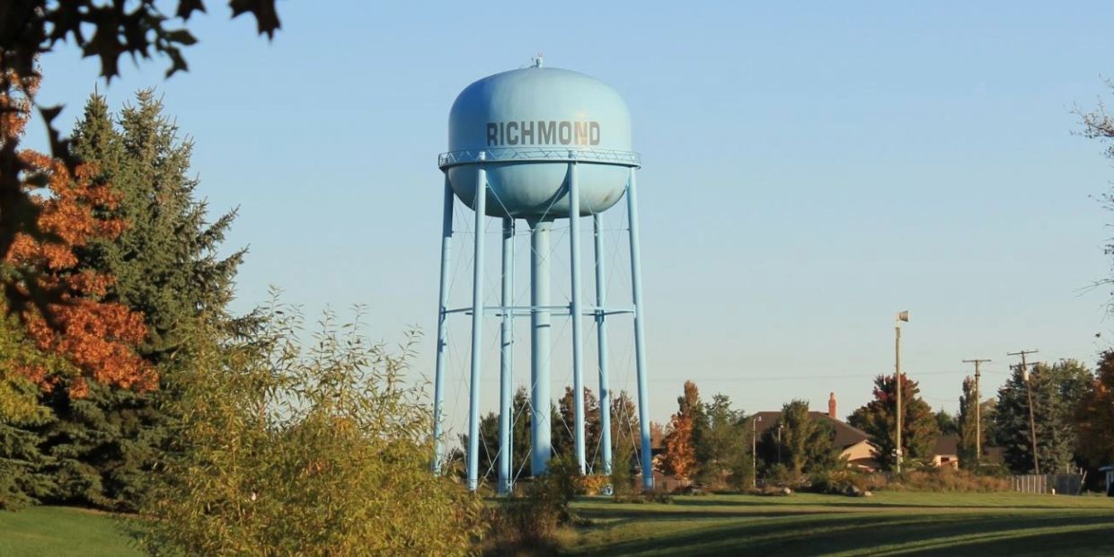 Blue Richmond water tower in a green, suburban area.