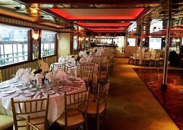 View of tables and chairs aboard boat