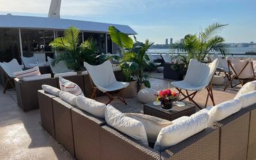 Top deck of Horizon's Edge, lounge chairs, couches and palms