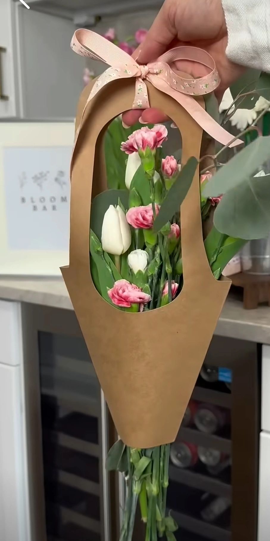 Women holding a bouquet of flowers.