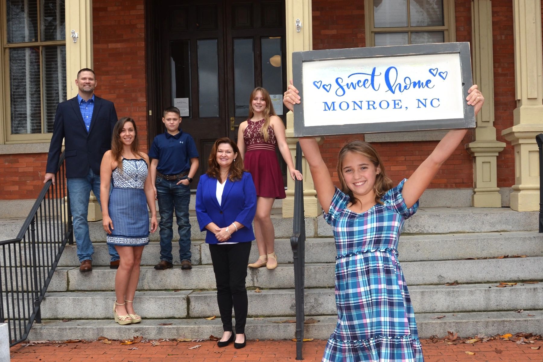 Blue Collar Realty posing for a picture at the Monroe Courthouse a staple of Monroe Real Estate