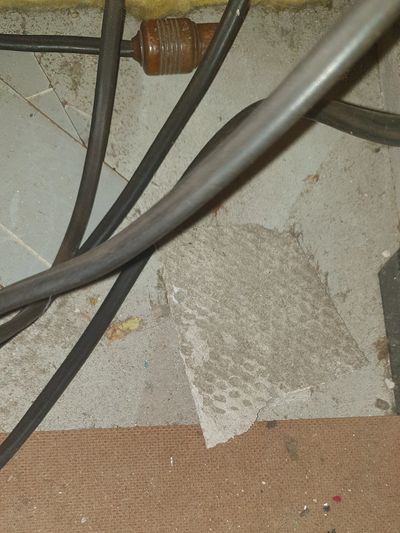 Damaged asbestos cement sheeting within a loft void.