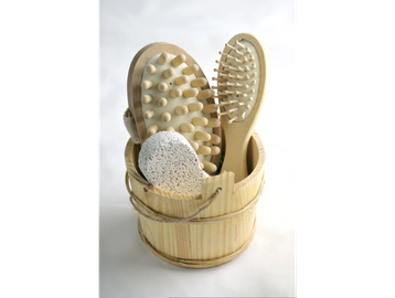 Wooden spa tools in a small bucket for body care.