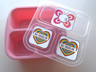 Pink divided container with lid showing "No Insulin" heart stickers and a butterfly label.