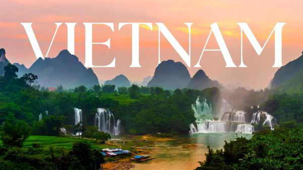 Scenic Vietnam landscape with waterfalls and mountains at sunset.