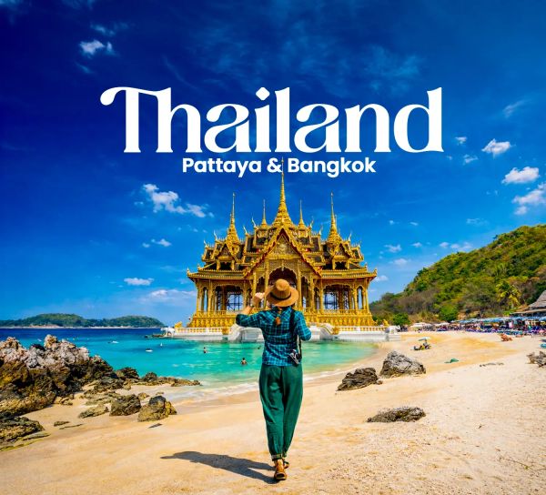 Tourist admiring golden temple on Thai beach under blue sky.