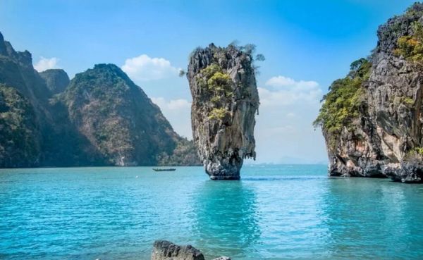 Limestone karst island in a turquoise sea.