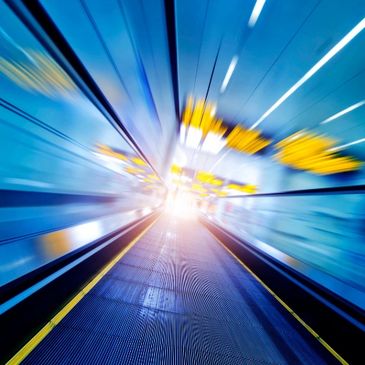 Abstract visual image of acceleration with bright light in the center that gives the impression of d