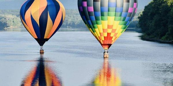 Splash & Dash.  Hot Air Balloons touching down in the river during a ride in Vermont.