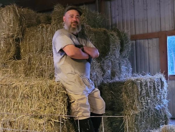 Joe stacking hay bales 