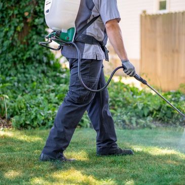 Man walking with lawn deodorizer equipment