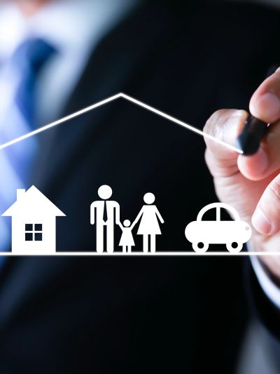 Hand drawing a protective house with family and car icons.