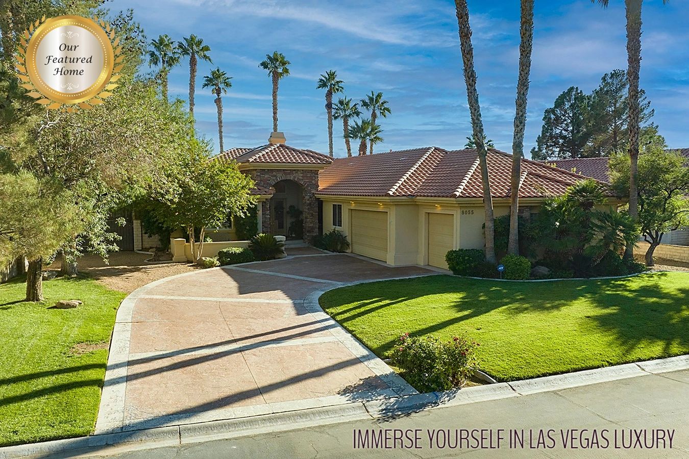 Single level stucco stone home 3-car garage curved driveway tall palm trees grass front yard