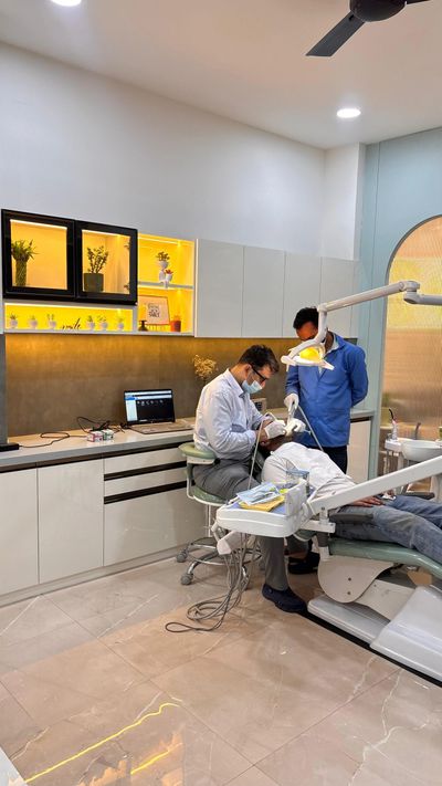 Dentist treating a patient in a modern clinic with assistant.