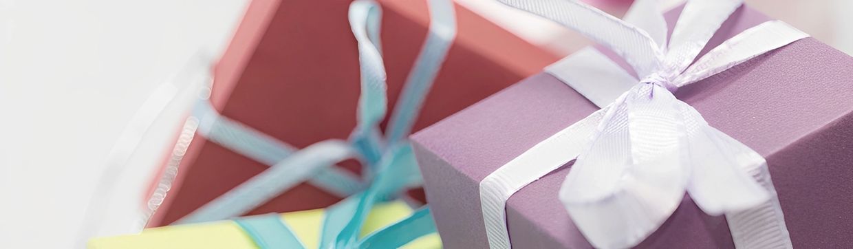 Colorful gift boxes tied with ribbons, suggesting presents or celebrations.