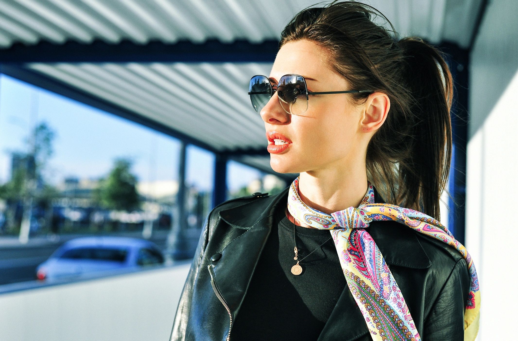 lady woman female wearing a scarf and sunglasses and lipstick while traveling looking very chic sexy