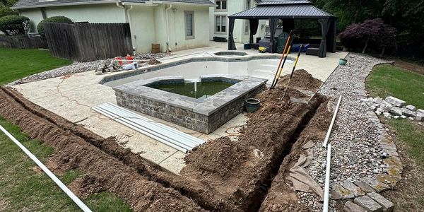 pool plumbing repair in the back yard at house