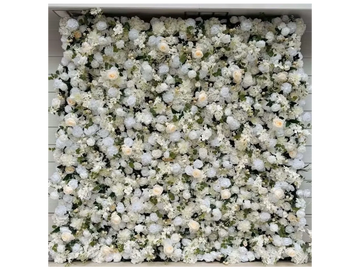 Image shows greenery backdrop featuring white flowers available for rent in midland texas