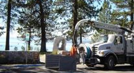 Vactor truck pumping near curb