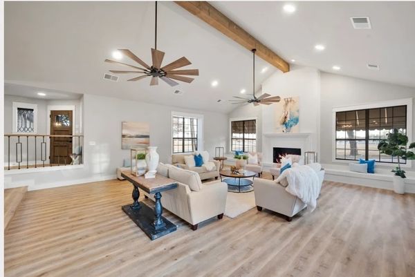 Spacious living room with modern furniture and large windows.