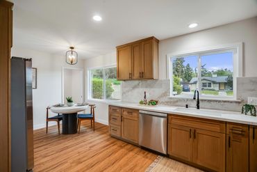 Bright kitchen with wooden cabinets and a cozy dining nook.