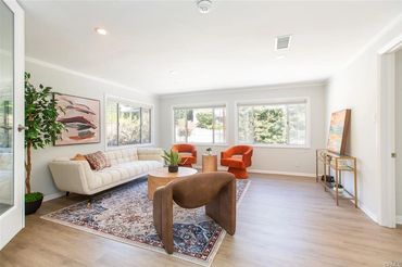 Bright living room with modern furniture and large windows letting in natural light.
