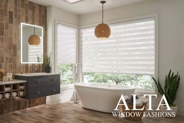 Modern bathroom with a freestanding tub and striped window shades.